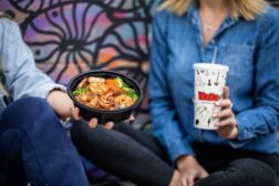 image of man and woman holding a meal from WaBa